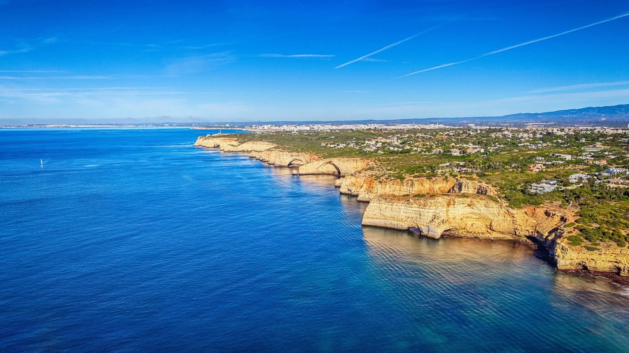 Dramatic ochre cliffs running along the Carvoeiro coastline
