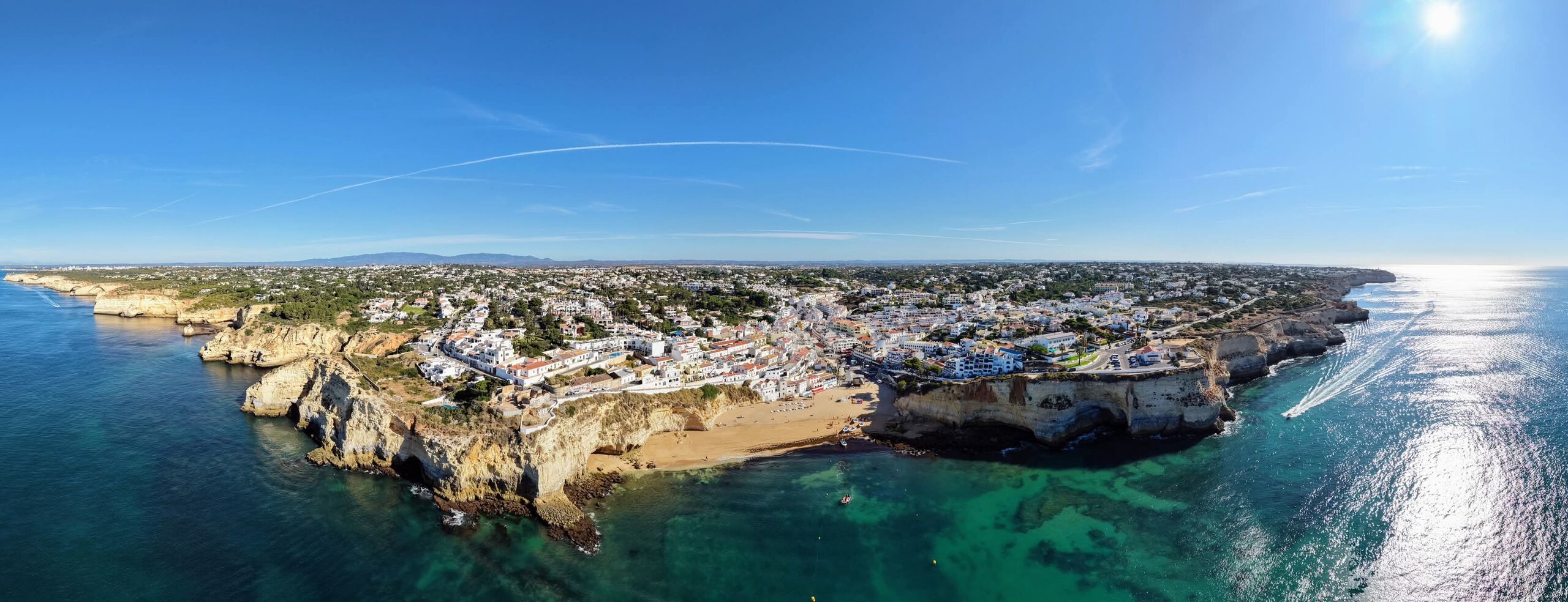 Sweeping aerial panorama of Carvoeiro village and its cliffs